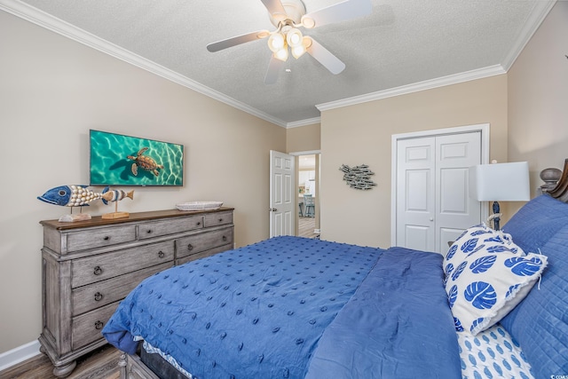 2405 Duffy St, North Myrtle Beach, SC 29582 - bedroom featuring ornamental molding, wood finished floors, a closet, a textured ceiling, and a ceiling fan