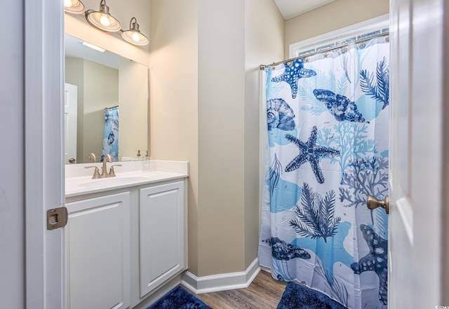 2405 Duffy St, North Myrtle Beach, SC 29582 - full bathroom with wood finished floors, vanity, and a shower with shower curtain