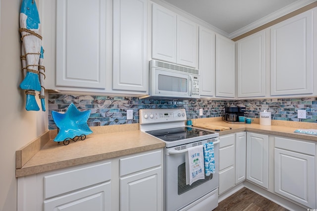 2405 Duffy St, North Myrtle Beach, SC 29582 - kitchen with white appliances, white cabinets, ornamental molding, and light countertops