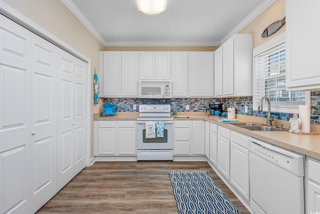 2405 Duffy St, North Myrtle Beach, SC 29582 - kitchen featuring white appliances, ornamental molding, light countertops, tasteful backsplash, and white cabinetry