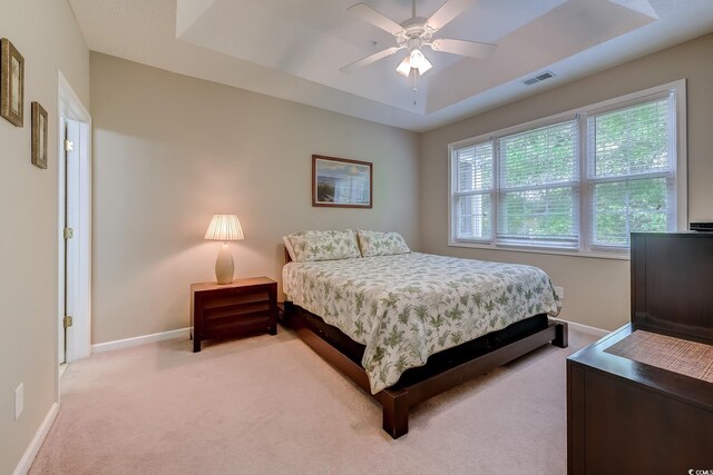 601 N Hillside Dr Unit 4434, North Myrtle Beach, SC 29582 - bedroom with light colored carpet, a tray ceiling, and a ceiling fan