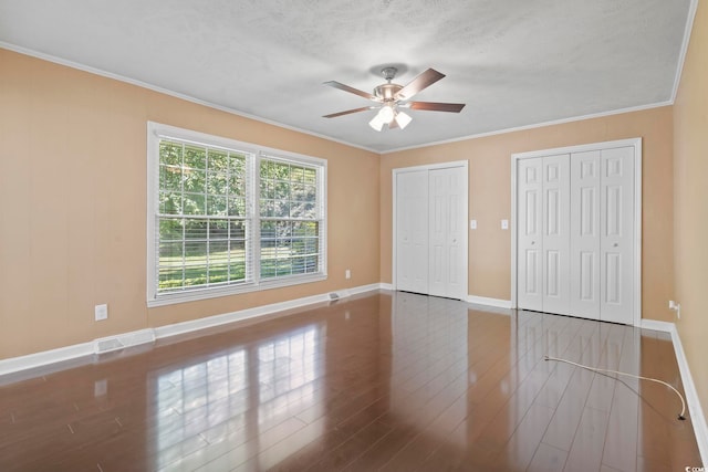 1043 S Main St, Aynor, SC 29511 - unfurnished bedroom featuring wood finished floors, two closets, ornamental molding, baseboards, and ceiling fan
