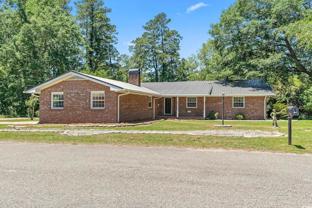 1043 S Main St, Aynor, SC 29511 - ranch-style house featuring a chimney, a front yard, and brick siding