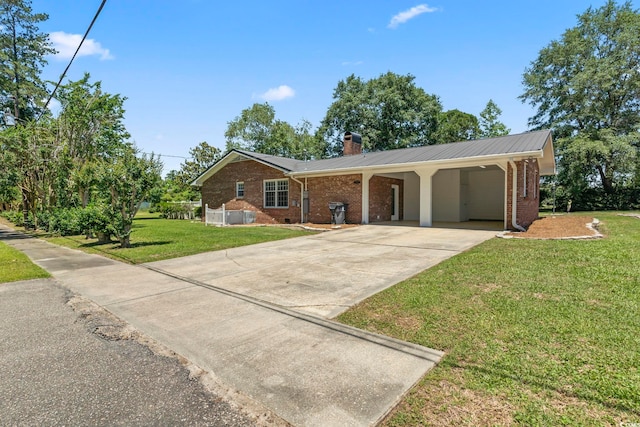 1043 S Main St, Aynor, SC 29511 - ranch-style home with a chimney, driveway, brick siding, and a front yard