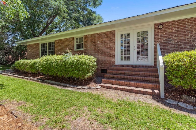 1043 S Main St, Aynor, SC 29511 - doorway to property featuring brick siding and a lawn