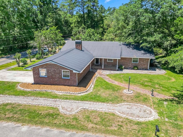 1043 S Main St, Aynor, SC 29511 - ranch-style home with brick siding, a front yard, a chimney, metal roof, and a porch