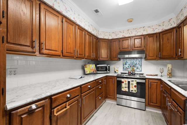578 Circle Dr, Myrtle Beach, SC 29575 - kitchen featuring stainless steel electric range, under cabinet range hood, decorative backsplash, brown cabinets, and crown molding