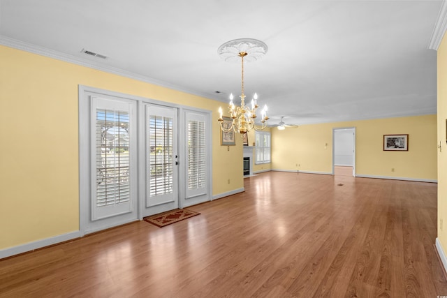 578 Circle Dr, Myrtle Beach, SC 29575 - unfurnished dining area with a chandelier, wood finished floors, baseboards, ornamental molding, and a glass covered fireplace