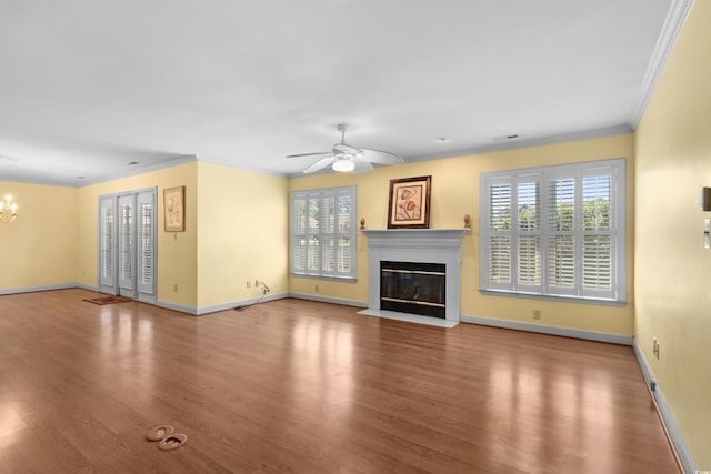 578 Circle Dr, Myrtle Beach, SC 29575 - unfurnished living room featuring wood finished floors, a fireplace with flush hearth, baseboards, ceiling fan, and a chandelier