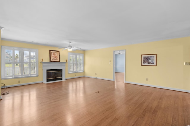 578 Circle Dr, Myrtle Beach, SC 29575 - unfurnished living room featuring a ceiling fan, wood finished floors, a fireplace with flush hearth, and baseboards