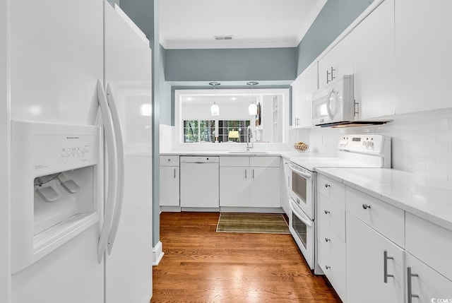 179 Golden Bear Dr Unit C4, Pawleys Island, SC 29585 - kitchen featuring white appliances, a sink, ornamental molding, white cabinetry, and wood finished floors
