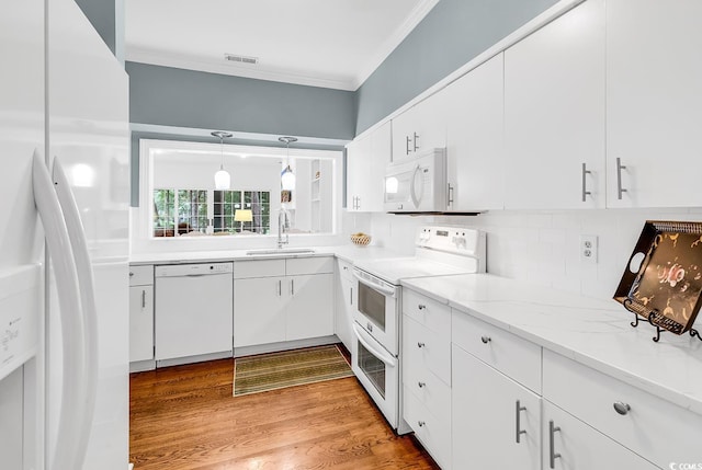 179 Golden Bear Dr Unit C4, Pawleys Island, SC 29585 - kitchen featuring white appliances, a sink, ornamental molding, and white cabinets