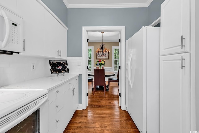 179 Golden Bear Dr Unit C4, Pawleys Island, SC 29585 - kitchen featuring white appliances, a chandelier, dark wood-style floors, backsplash, and white cabinetry