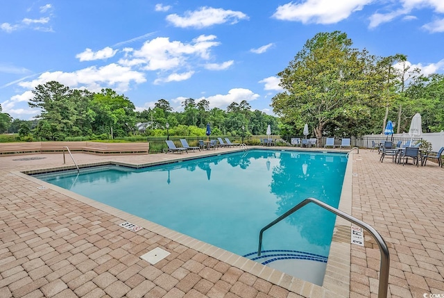179 Golden Bear Dr Unit C4, Pawleys Island, SC 29585 - community pool featuring a patio and view of wooded area