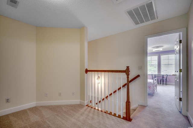 205 Threshing Way Unit 1052, Myrtle Beach, SC 29579 - hallway featuring an upstairs landing, carpet floors, a textured ceiling, and baseboards