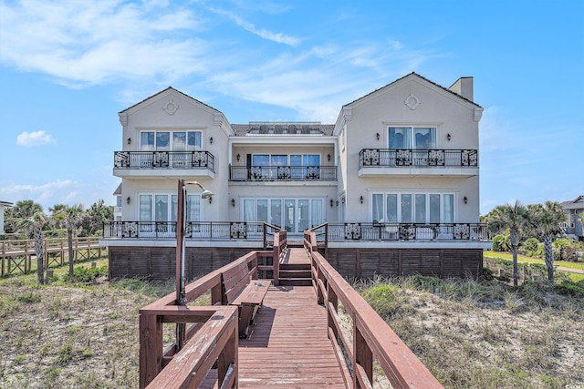 123 Pioneer Loop, Georgetown, SC 29440 - back of property with a balcony, french doors, and stucco siding