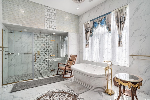 123 Pioneer Loop, Georgetown, SC 29440 - bathroom featuring marble tiled flooring, a marble finish shower, a freestanding tub, and tile walls