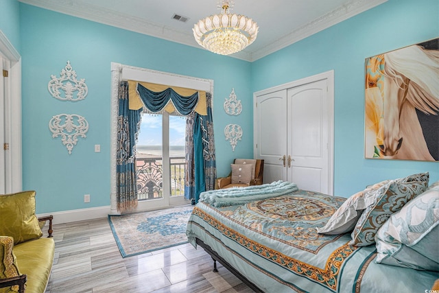 123 Pioneer Loop, Georgetown, SC 29440 - bedroom with a chandelier, access to exterior, a closet, crown molding, and baseboards