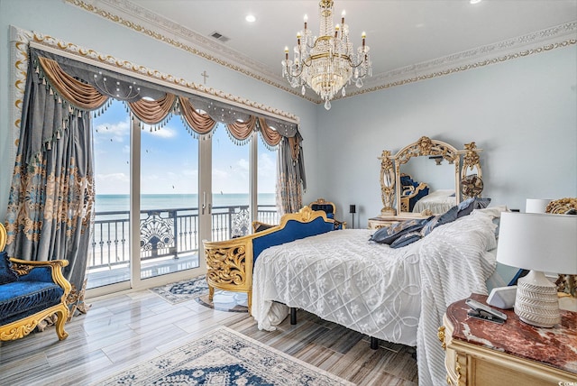 123 Pioneer Loop, Georgetown, SC 29440 - bedroom featuring access to exterior, a chandelier, a water view, ornamental molding, and recessed lighting