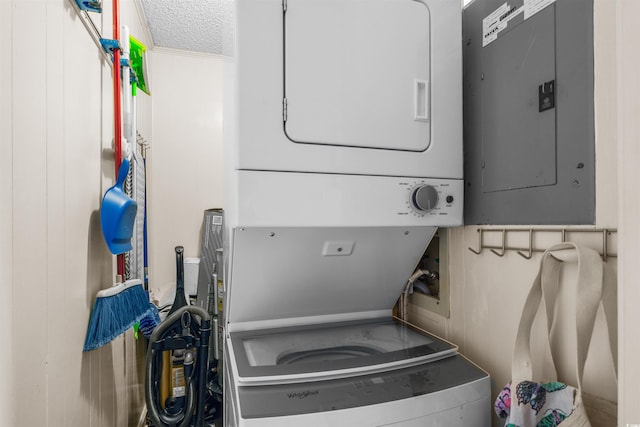 6309 N Ocean Blvd Unit 14E, North Myrtle Beach, SC 29582 - laundry room with estacked washer and dryer, electric panel, and a textured ceiling