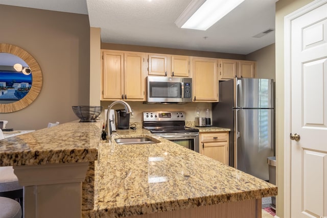 1221 Tidewater Dr Unit 2112, North Myrtle Beach, SC 29582 - kitchen with stainless steel appliances, a sink, light brown cabinets, and a peninsula