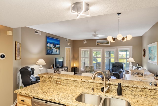 1221 Tidewater Dr Unit 2112, North Myrtle Beach, SC 29582 - kitchen featuring open floor plan, a sink, light stone countertops, stainless steel dishwasher, and a textured ceiling