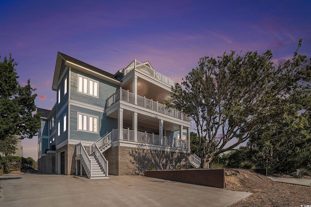139 Pioneer Loop, Georgetown, SC 29440 - beach home with a balcony, stairs, brick siding, and driveway
