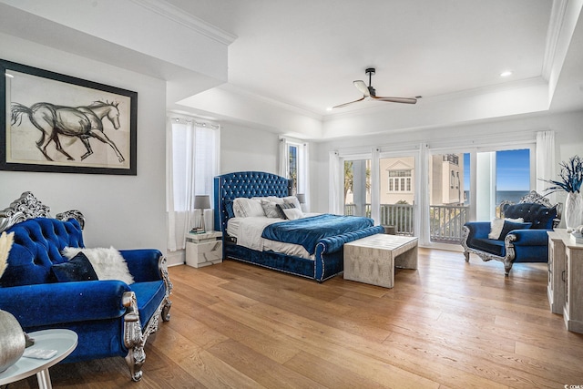 139 Pioneer Loop, Georgetown, SC 29440 - bedroom with a tray ceiling, access to exterior, ornamental molding, light wood-style flooring, and a ceiling fan