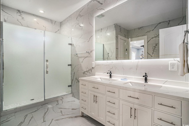 139 Pioneer Loop, Georgetown, SC 29440 - bathroom with double vanity, a marble finish shower, marble finish flooring, tile walls, and recessed lighting
