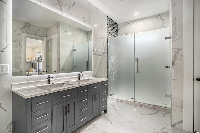139 Pioneer Loop, Georgetown, SC 29440 - bathroom with marble tiled floors, a marble finish shower, stone wall, recessed lighting, and tile walls