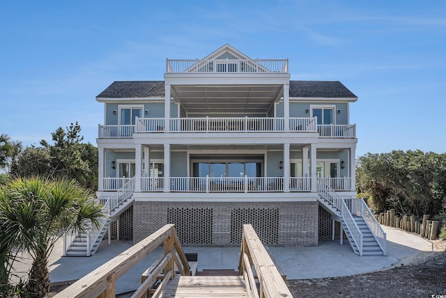 139 Pioneer Loop, Georgetown, SC 29440 - view of front of house with stairway, a balcony, and a shingled roof