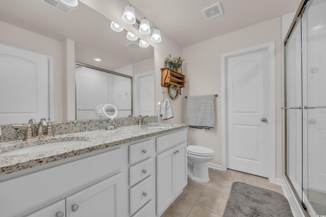 132 Machrie Loop Unit A, Myrtle Beach, SC 29588 - bathroom featuring a stall shower, double vanity, tile patterned flooring, and toilet