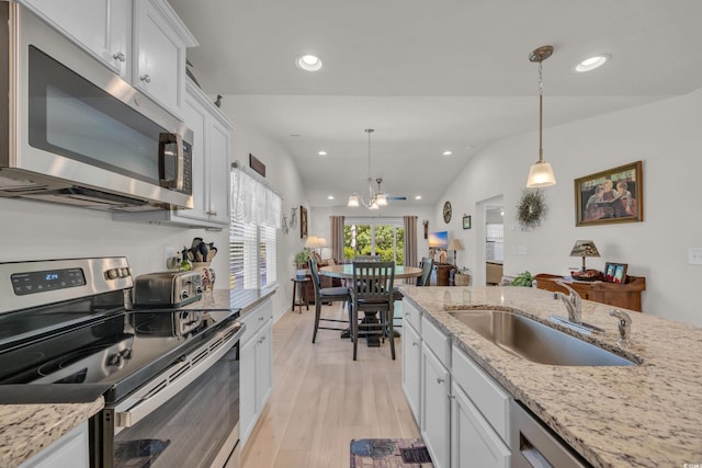 132 Machrie Loop Unit A, Myrtle Beach, SC 29588 - kitchen with stainless steel appliances, a sink, recessed lighting, white cabinetry, and decorative light fixtures