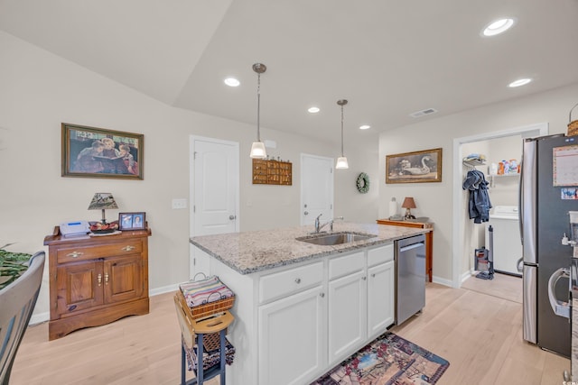 132 Machrie Loop Unit A, Myrtle Beach, SC 29588 - kitchen featuring appliances with stainless steel finishes, a sink, white cabinetry, light wood-style floors, and light stone countertops