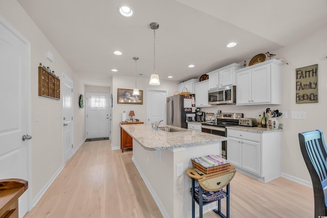 132 Machrie Loop Unit A, Myrtle Beach, SC 29588 - kitchen featuring stainless steel appliances, a sink, light wood-style flooring, white cabinetry, and recessed lighting