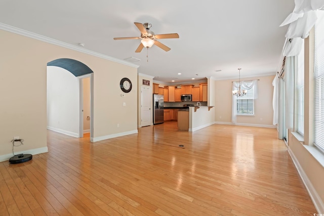 278 Carolina Crossing Blvd, Little River, SC 29566 - unfurnished living room with ornamental molding, a ceiling fan, light wood finished floors, a chandelier, and arched walkways