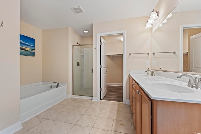 278 Carolina Crossing Blvd, Little River, SC 29566 - full bathroom with a bath, a stall shower, a walk in closet, double vanity, and tile patterned flooring
