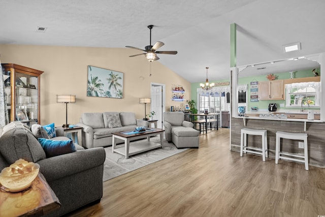 990 Chateau Dr, Conway, SC 29526 - living area featuring a ceiling fan, a chandelier, vaulted ceiling, and light wood-style flooring
