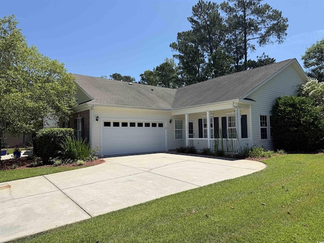 152 Rose Water Loop, Myrtle Beach, SC 29588 - view of front of home with covered porch, a garage, concrete driveway, a front lawn, and roof with shingles