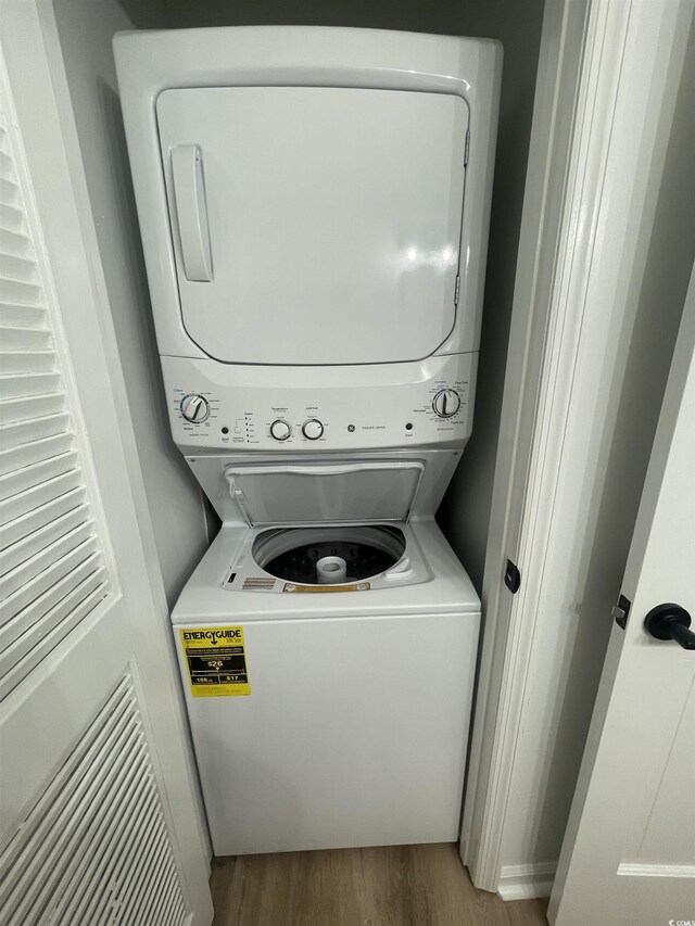 1509 N Waccamaw Dr Unit 112, Murrells Inlet, SC 29576 - laundry room featuring stacked washer / dryer and wood finished floors