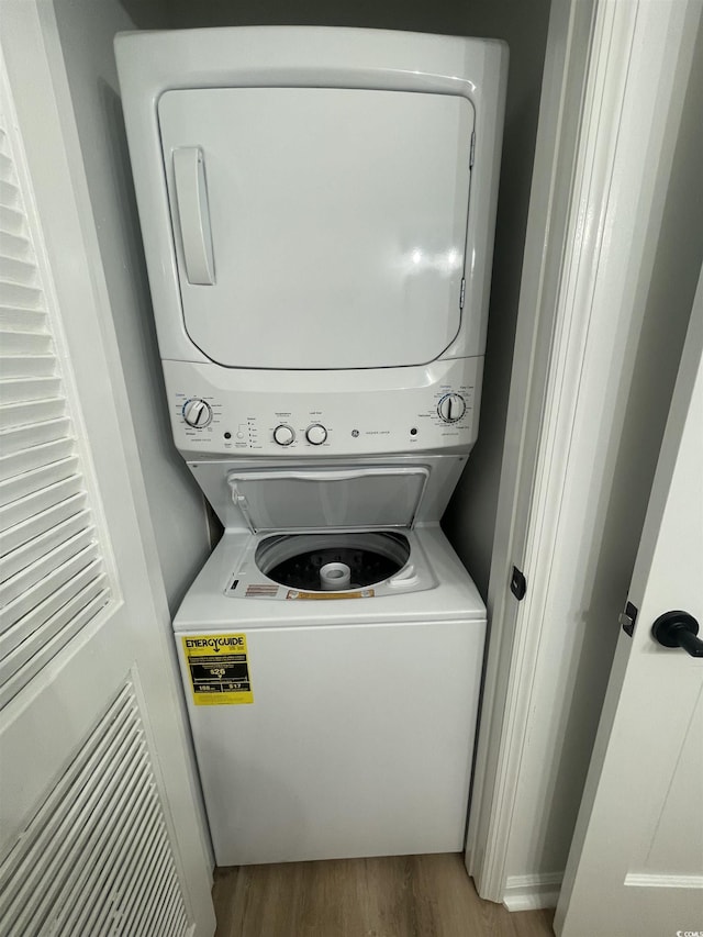 1509 N Waccamaw Dr Unit 112, Murrells Inlet, SC 29576 - laundry area with stacked washer / dryer and wood finished floors