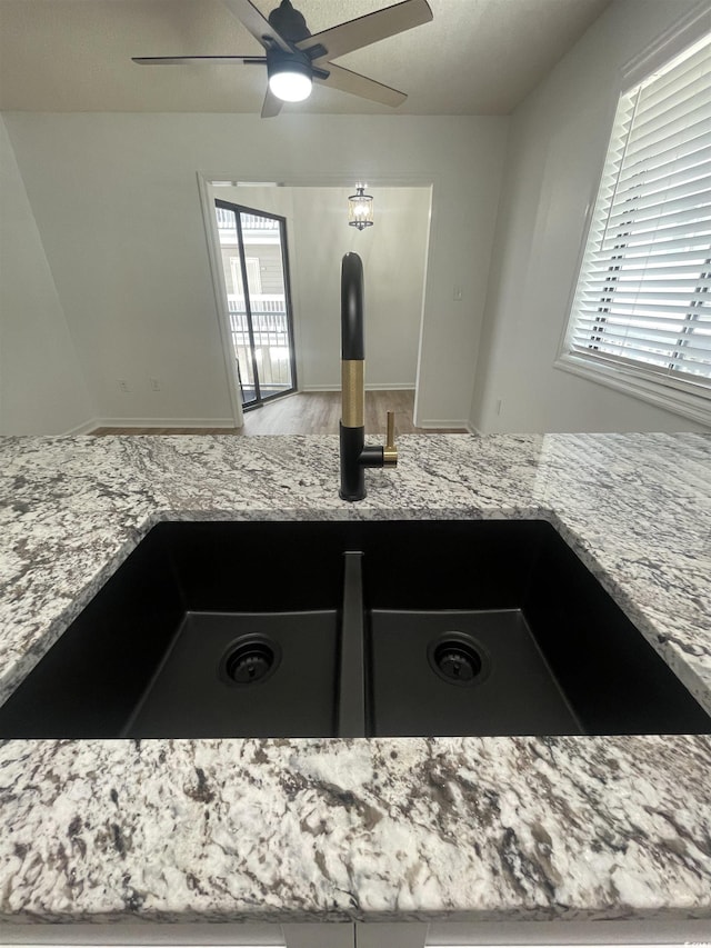 1509 N Waccamaw Dr Unit 112, Murrells Inlet, SC 29576 - kitchen view of a sink, light stone counters, and ceiling fan