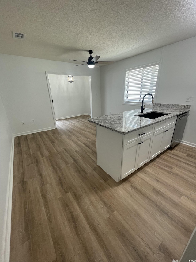 1509 N Waccamaw Dr Unit 112, Murrells Inlet, SC 29576 - kitchen with a sink, stainless steel dishwasher, wood finished floors, a ceiling fan, and a textured ceiling