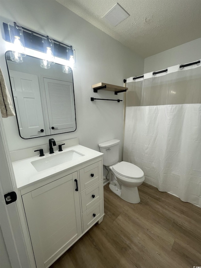 1509 N Waccamaw Dr Unit 112, Murrells Inlet, SC 29576 - full bath featuring wood finished floors, vanity, toilet, a shower with curtain, and a textured ceiling