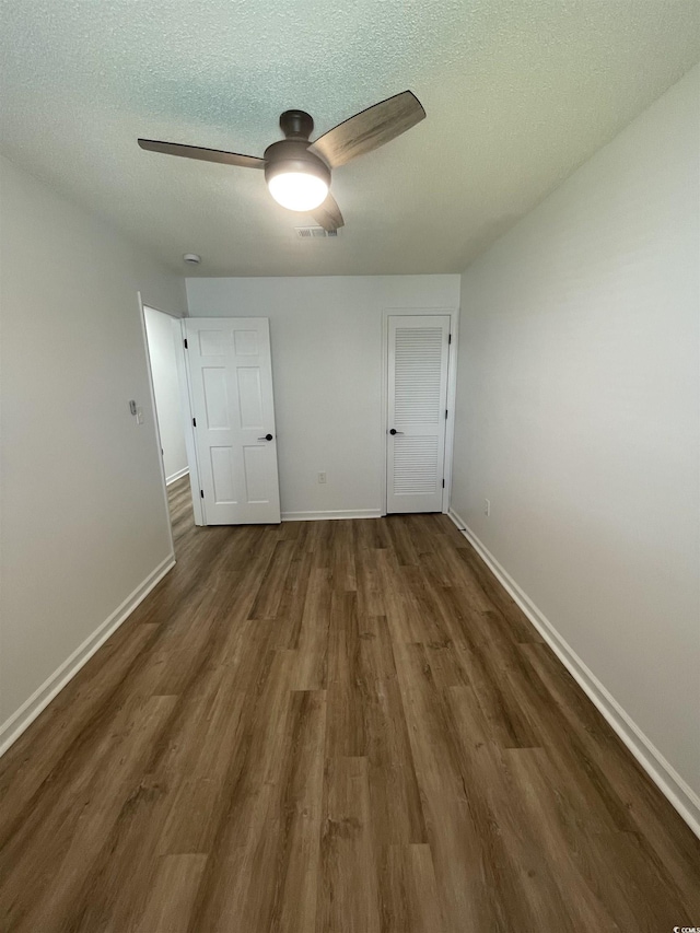 1509 N Waccamaw Dr Unit 112, Murrells Inlet, SC 29576 - unfurnished bedroom with wood finished floors, a textured ceiling, baseboards, and a ceiling fan