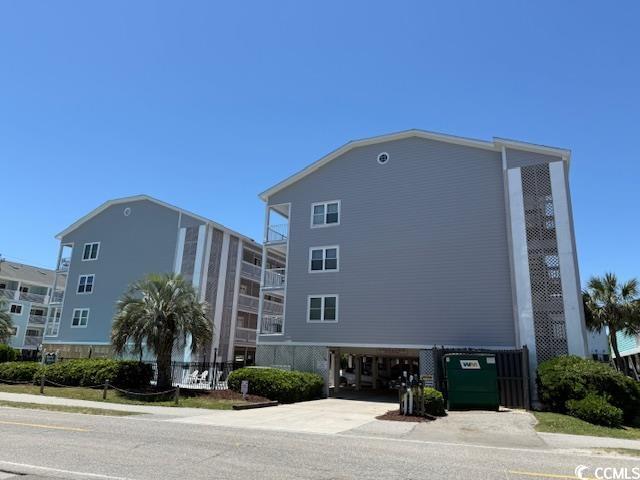 1509 N Waccamaw Dr Unit 112, Murrells Inlet, SC 29576 - view of building exterior with a carport and concrete driveway