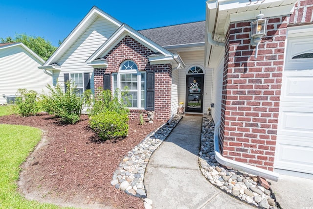 359 Harbour Reef Dr, Myrtle Beach, SC 29588 - doorway to property featuring brick siding, a shingled roof, and an attached garage