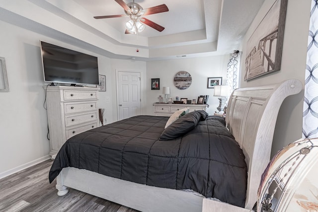 359 Harbour Reef Dr, Myrtle Beach, SC 29588 - bedroom with a tray ceiling, wood finished floors, baseboards, and a ceiling fan