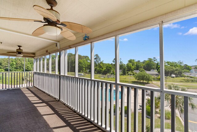 4350 Intercoastal Dr Unit 2408, Little River, SC 29566 - unfurnished sunroom with ceiling fan and view of scattered trees