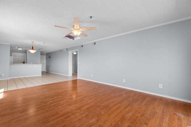 4350 Intercoastal Dr Unit 2408, Little River, SC 29566 - unfurnished living room with a textured ceiling, a ceiling fan, light wood-style floors, baseboards, and ornamental molding